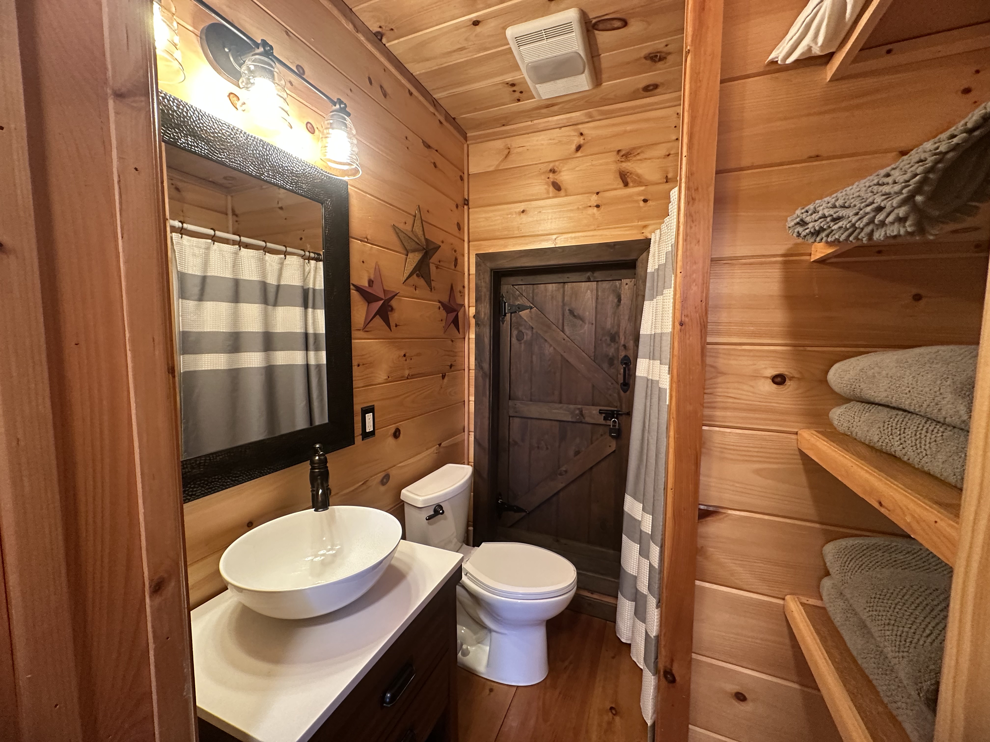 Lower level bathroom with a standing shower for the terrace suite.